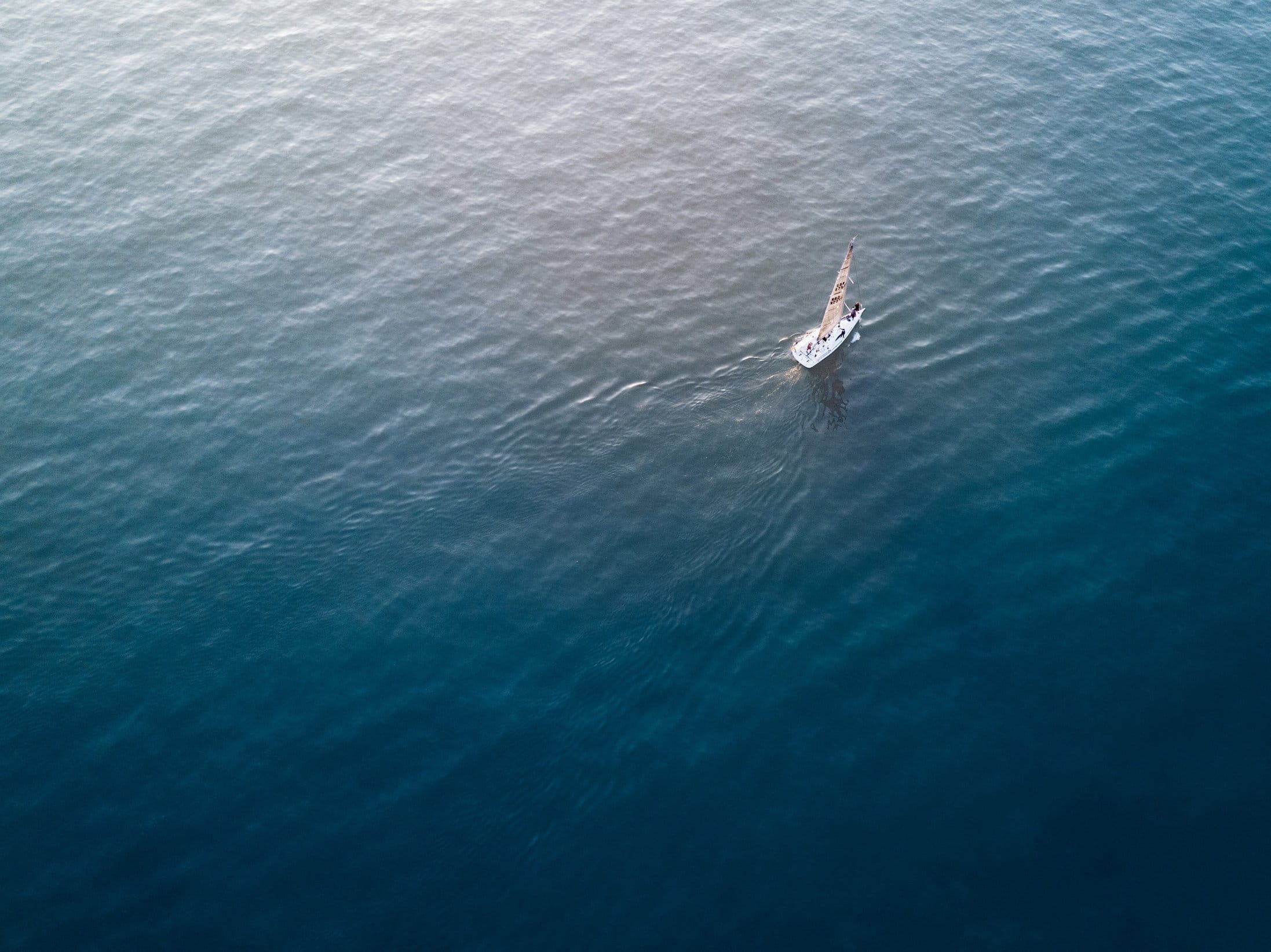 Aerial view of a yacht sailing on the deep blue Mediterranean off Malta